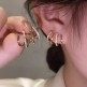 Paire de boucles d'oreilles dorés ou argentés